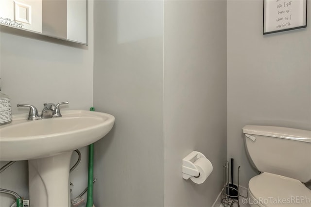 bathroom featuring toilet and sink