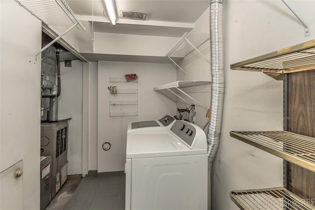 clothes washing area featuring separate washer and dryer