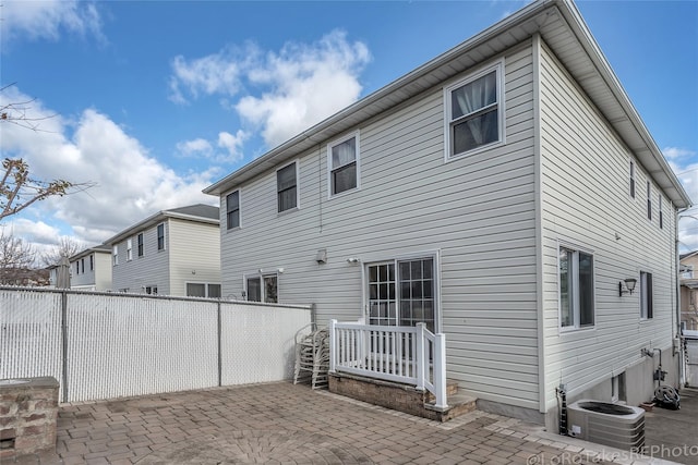 rear view of house featuring a patio and central AC unit