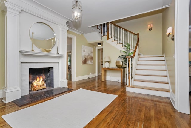 entryway featuring hardwood / wood-style floors and crown molding