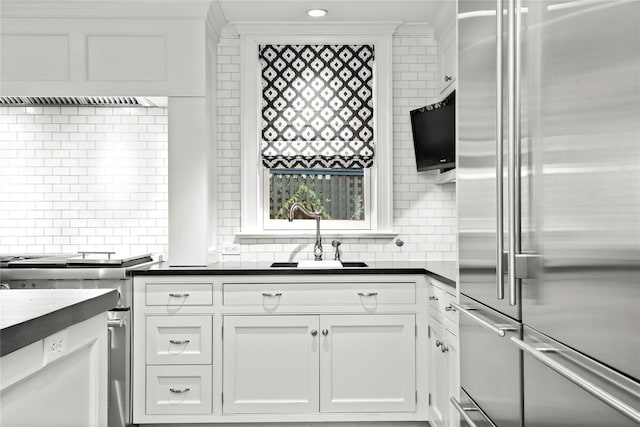 kitchen featuring white cabinets, sink, ornamental molding, and stainless steel appliances