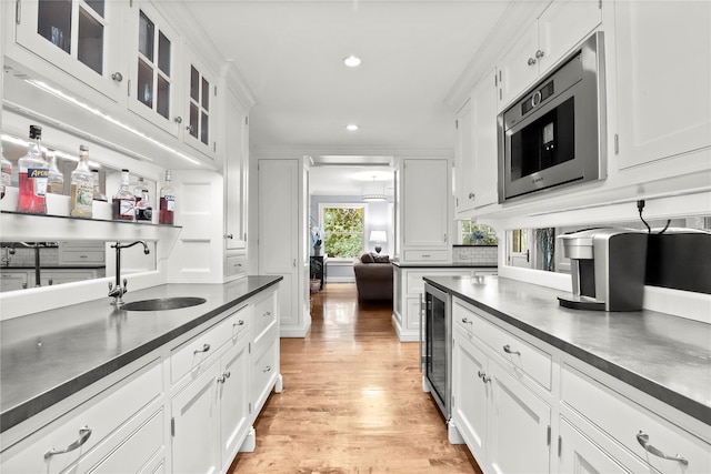 kitchen with white cabinets, stainless steel microwave, and sink