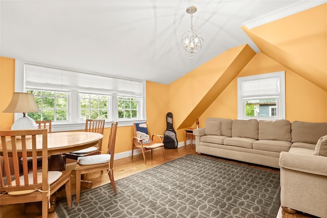 living room featuring a chandelier, vaulted ceiling, and hardwood / wood-style flooring