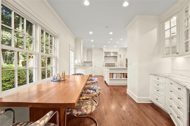 dining room featuring hardwood / wood-style flooring and crown molding