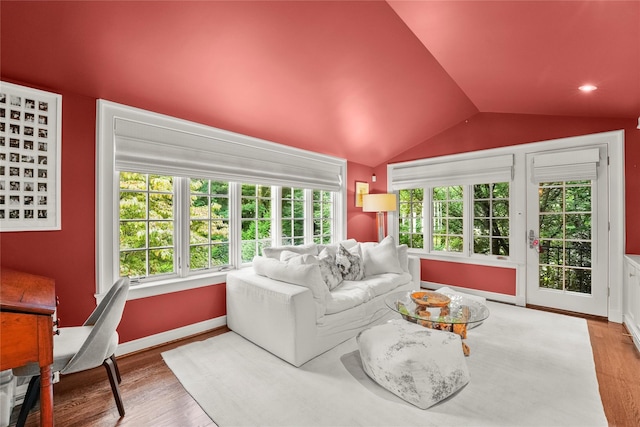 living room with light wood-type flooring and lofted ceiling