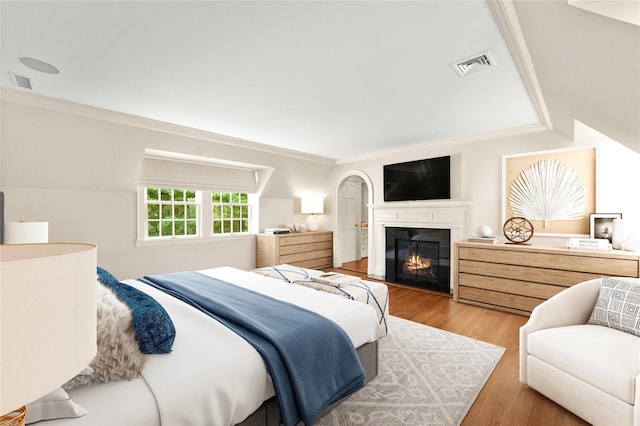 bedroom with crown molding and light wood-type flooring