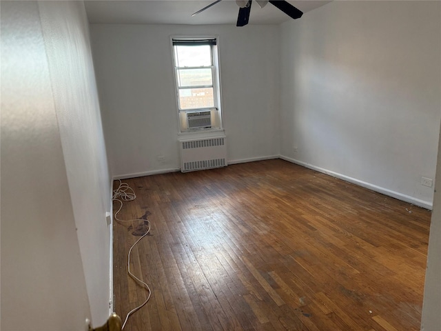 unfurnished room with radiator, ceiling fan, cooling unit, and dark wood-type flooring