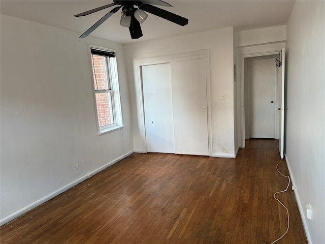 unfurnished bedroom featuring ceiling fan, dark hardwood / wood-style floors, and a closet