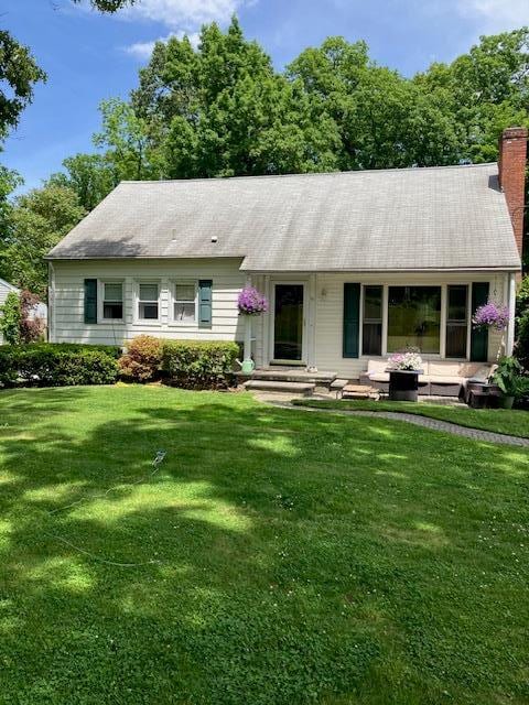 back of house with a lawn