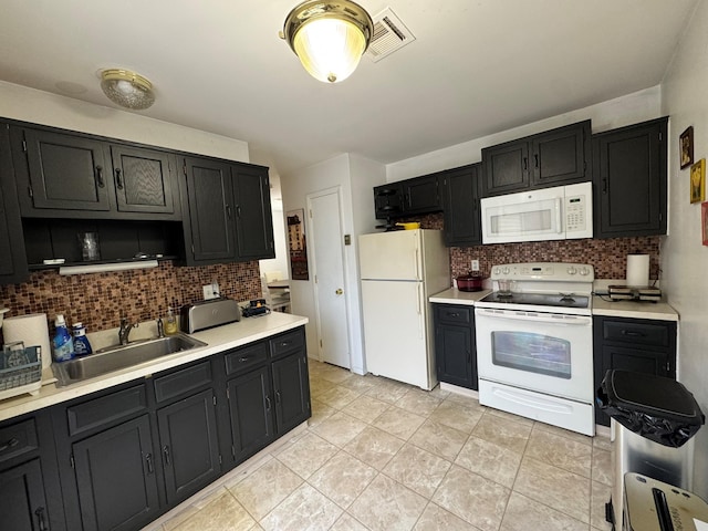 kitchen featuring decorative backsplash, white appliances, sink, and light tile patterned floors