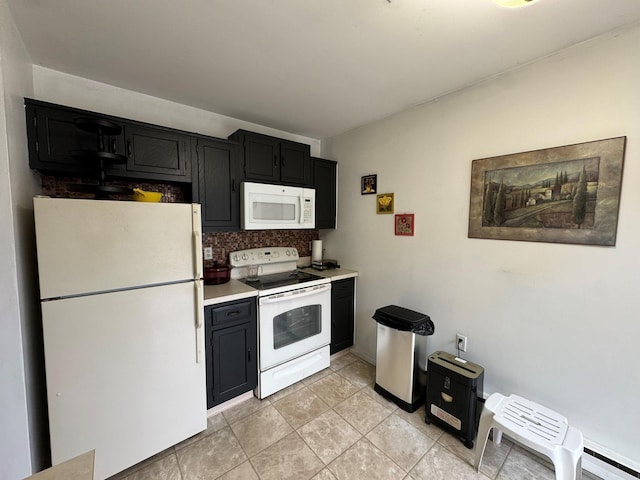 kitchen featuring light tile patterned floors, white appliances, and tasteful backsplash