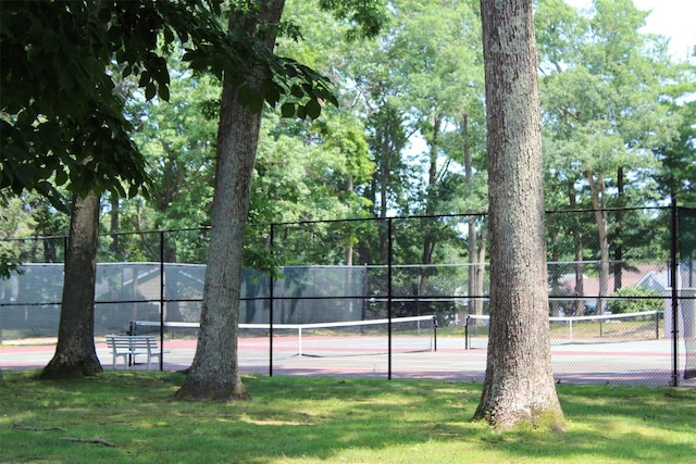 view of sport court featuring a yard