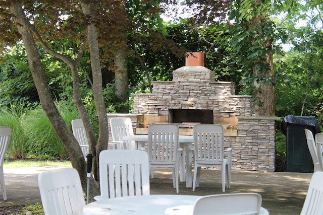 view of patio featuring an outdoor stone fireplace