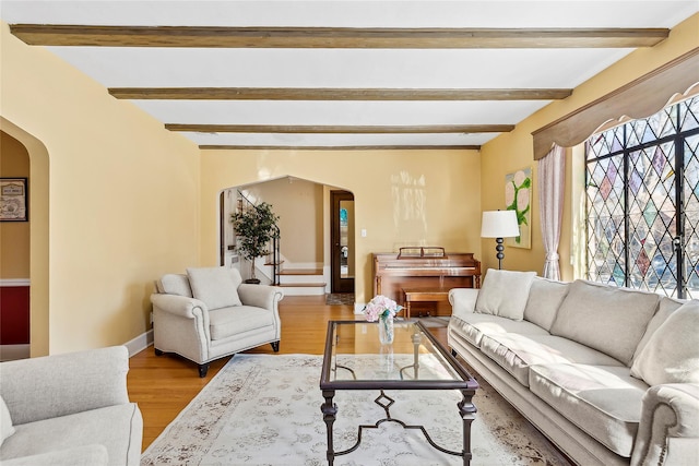 living room with beamed ceiling and hardwood / wood-style floors