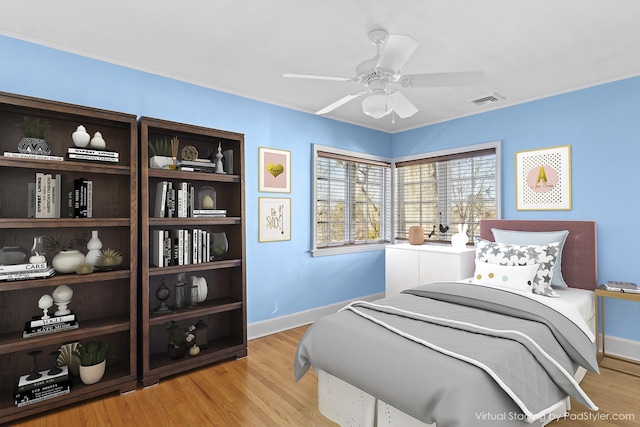 bedroom with ceiling fan and light wood-type flooring