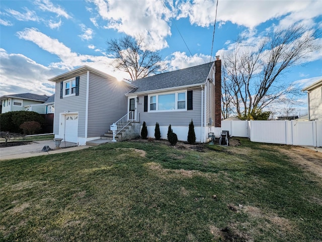 view of front of property with a front yard and a garage