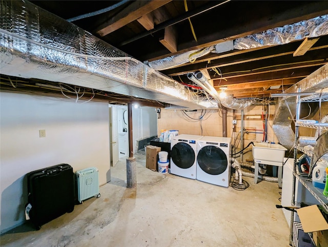 basement with sink and washing machine and clothes dryer