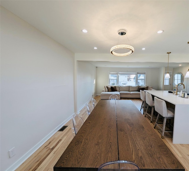 corridor with light hardwood / wood-style floors