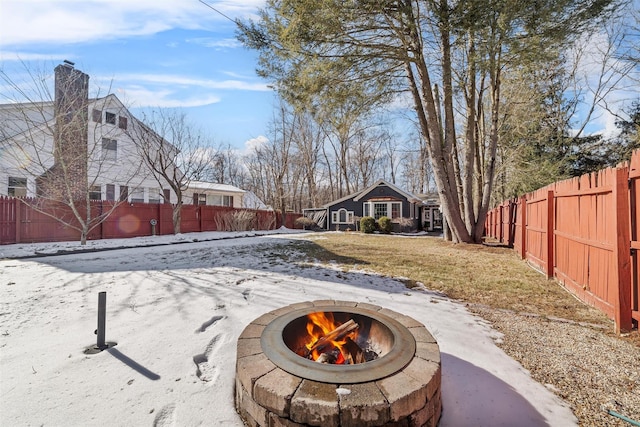 snowy yard featuring a fire pit