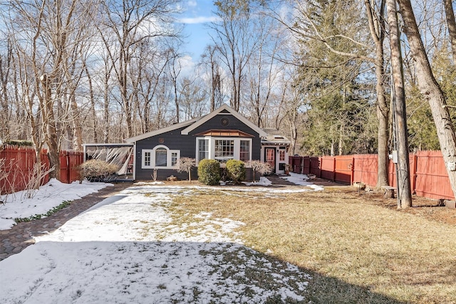 snow covered back of property with a lawn