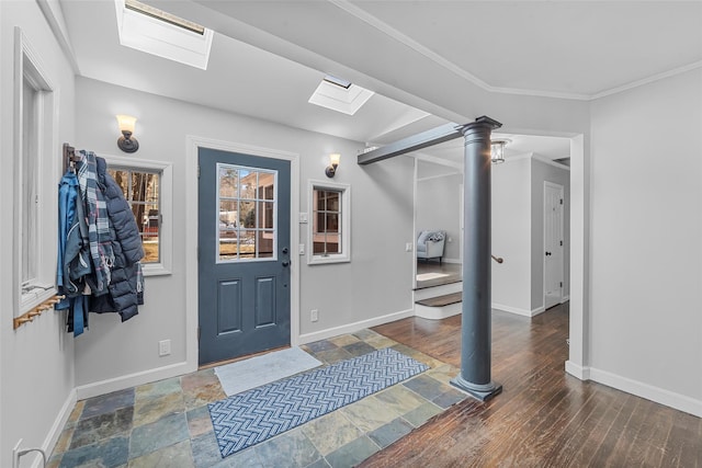 foyer entrance featuring crown molding, dark hardwood / wood-style floors, and a skylight