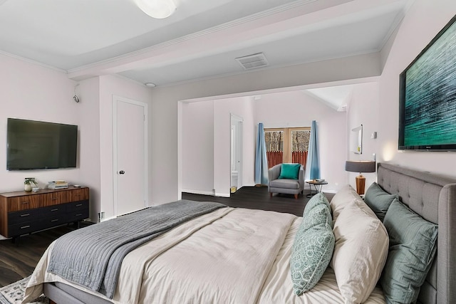 bedroom with crown molding and dark wood-type flooring