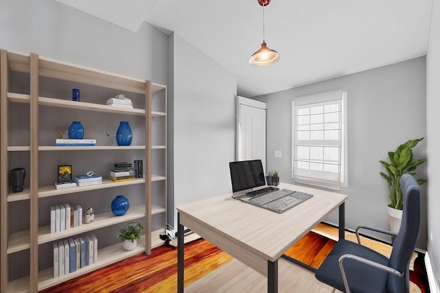 office with lofted ceiling and hardwood / wood-style floors