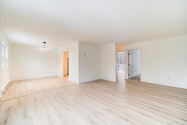 empty room with ceiling fan, light hardwood / wood-style flooring, and a baseboard radiator