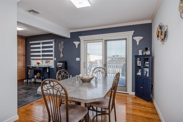 dining room featuring hardwood / wood-style flooring and ornamental molding