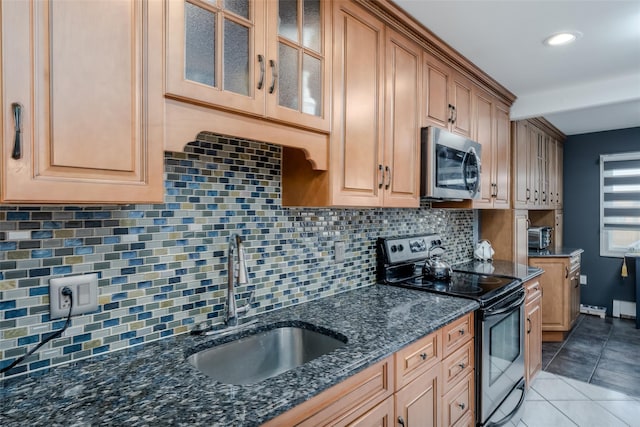 kitchen featuring sink, black electric range, decorative backsplash, dark stone countertops, and light tile patterned flooring