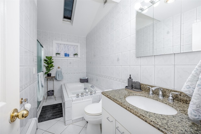 bathroom with vanity, tile patterned flooring, toilet, tile walls, and a tub