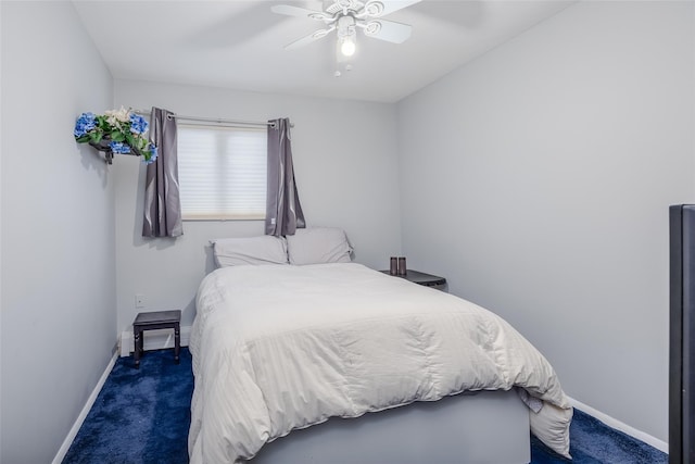 bedroom featuring ceiling fan and dark carpet