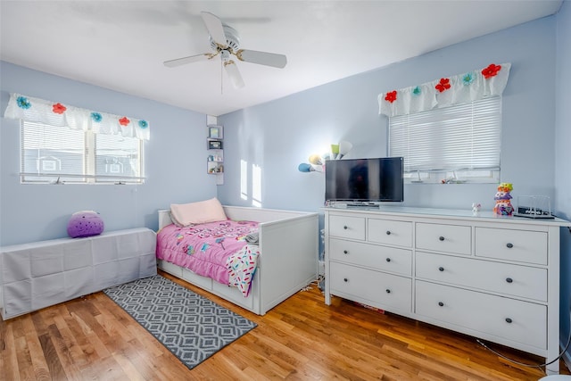 bedroom with ceiling fan and light wood-type flooring