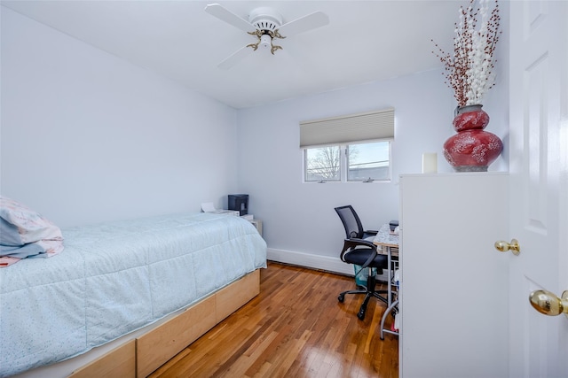 bedroom with ceiling fan and hardwood / wood-style floors