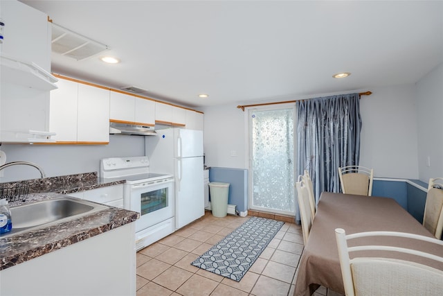 kitchen featuring white cabinetry, sink, dark stone countertops, white appliances, and light tile patterned flooring