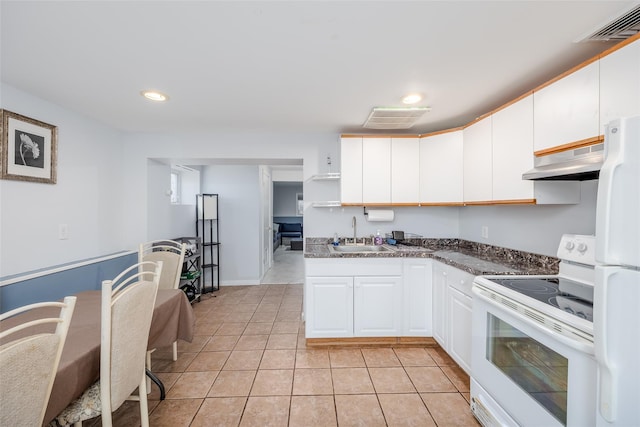 kitchen featuring sink, white cabinets, extractor fan, white appliances, and light tile patterned flooring