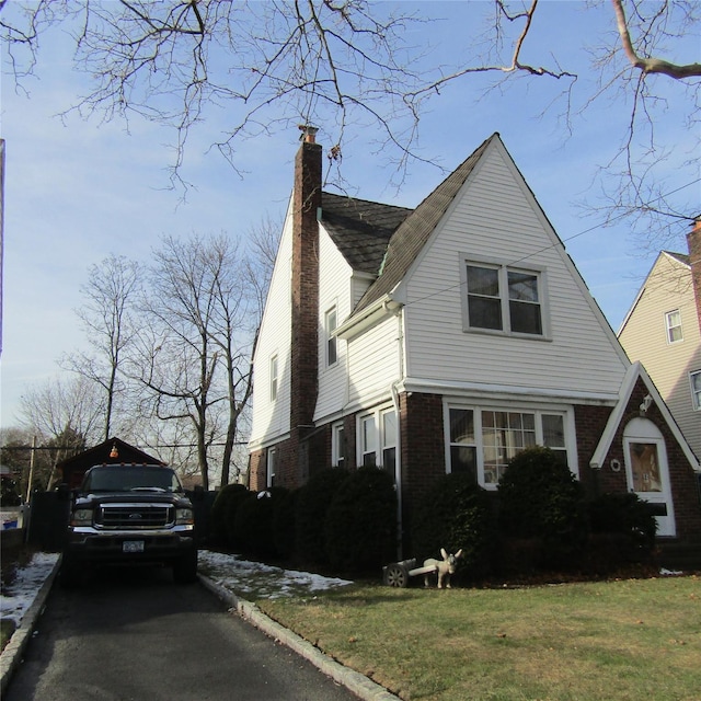 view of side of home featuring a yard