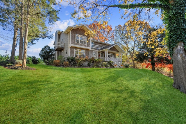 view of property with a porch and a front lawn