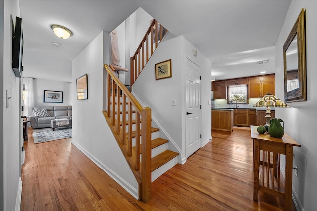 stairway with hardwood / wood-style flooring