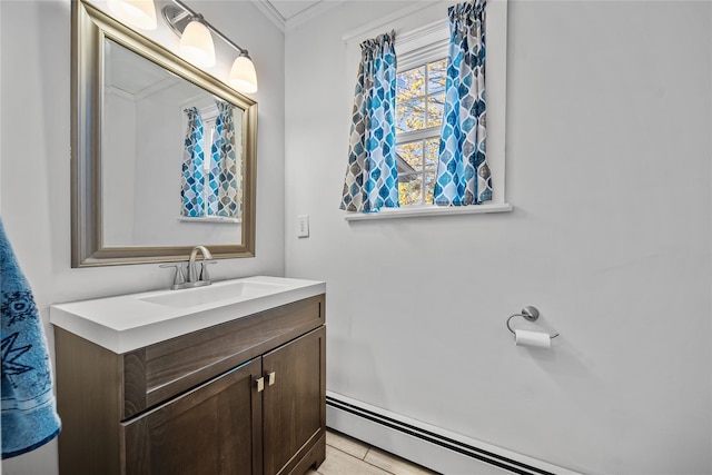 bathroom with vanity, a baseboard heating unit, and crown molding