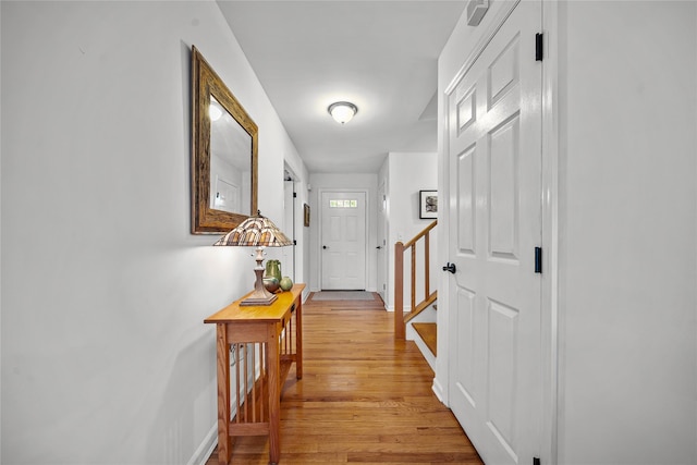 corridor with light hardwood / wood-style flooring