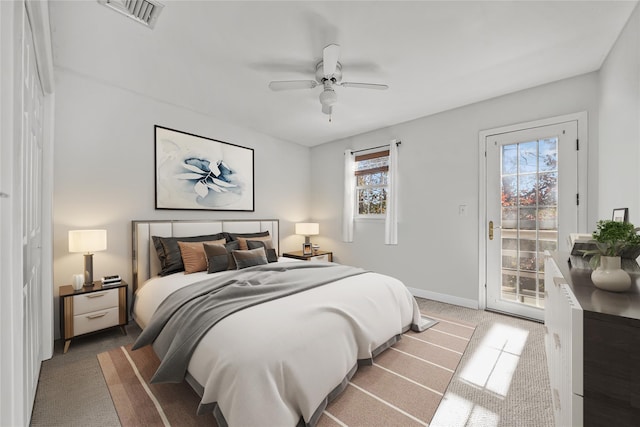 carpeted bedroom with ceiling fan, access to exterior, and multiple windows