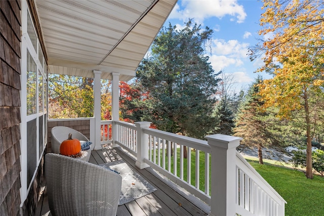 wooden terrace featuring a lawn