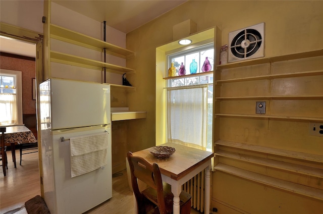 kitchen with light hardwood / wood-style flooring and white refrigerator