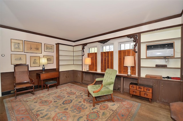 sitting room featuring wood walls, wood-type flooring, a wall mounted air conditioner, and ornamental molding