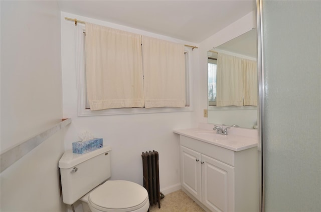 bathroom with vanity, toilet, and radiator