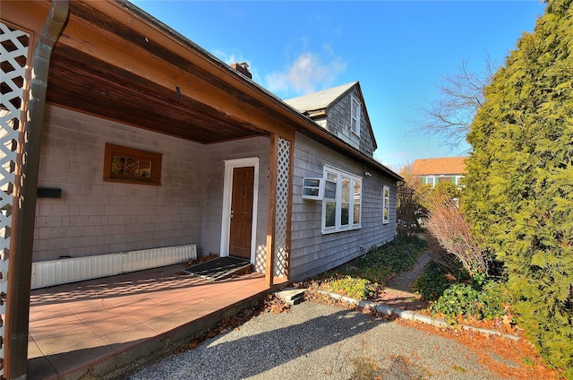 view of exterior entry featuring a patio area