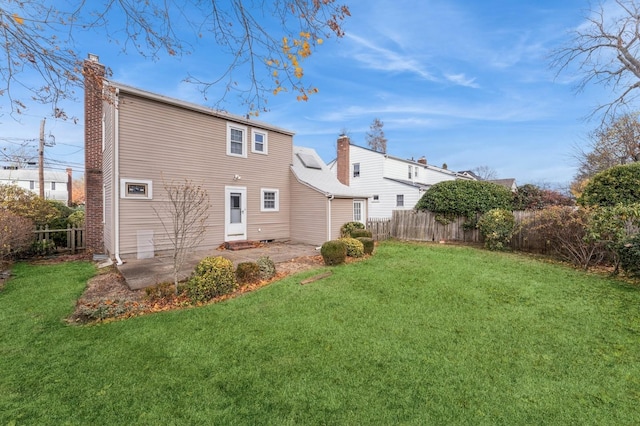 rear view of property with a patio area and a yard