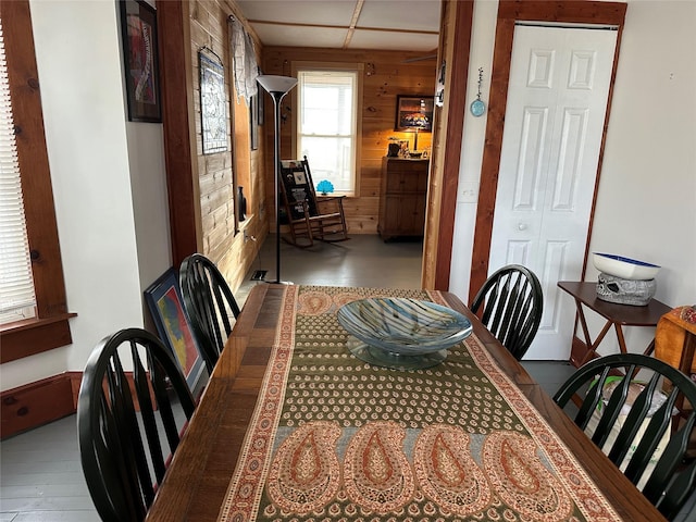 dining area featuring wooden walls