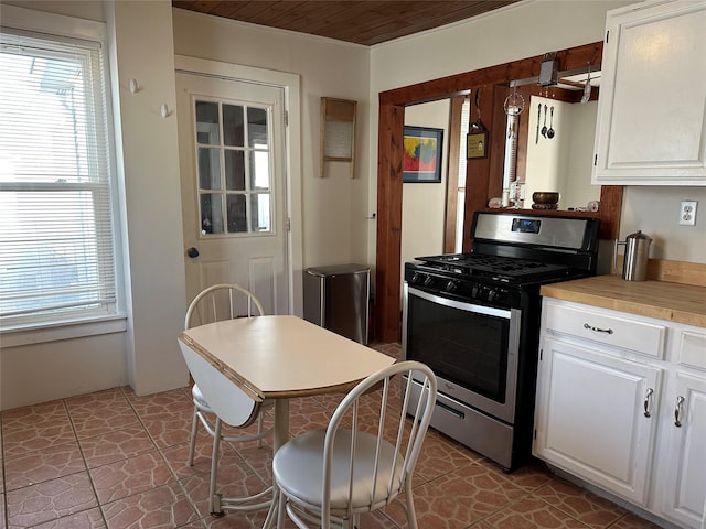 kitchen with white cabinets, wooden ceiling, and stainless steel range with gas stovetop